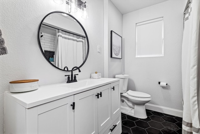 bathroom featuring tile patterned flooring, vanity, and toilet