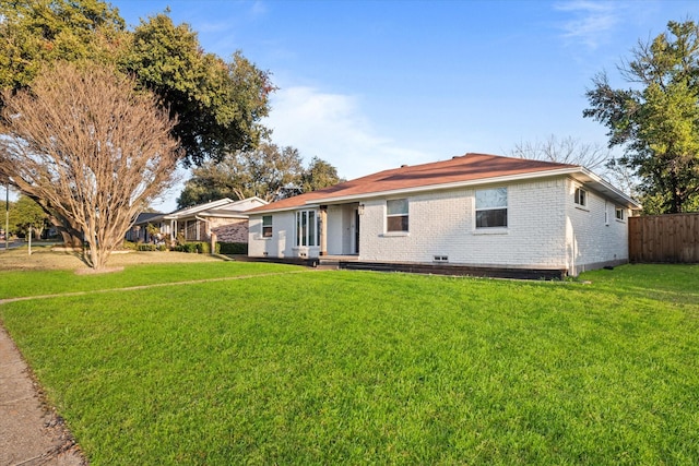 ranch-style home featuring a front yard