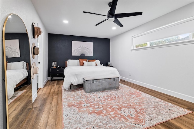 bedroom with ceiling fan and wood-type flooring