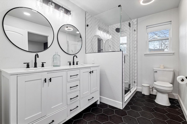 bathroom featuring tile patterned floors, vanity, toilet, and a shower with door