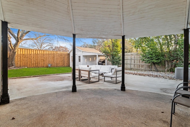 view of patio / terrace featuring an outdoor living space, an outbuilding, and cooling unit