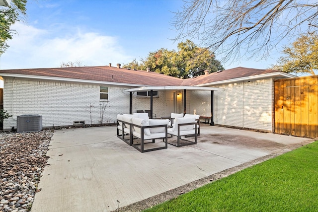 rear view of house featuring a patio area, an outdoor living space, and central AC unit