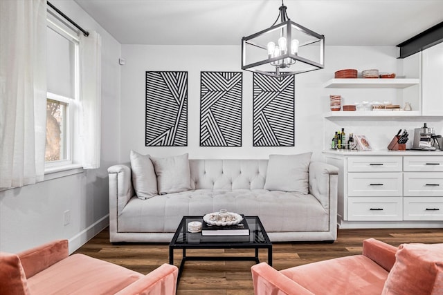 living room featuring dark hardwood / wood-style flooring and an inviting chandelier