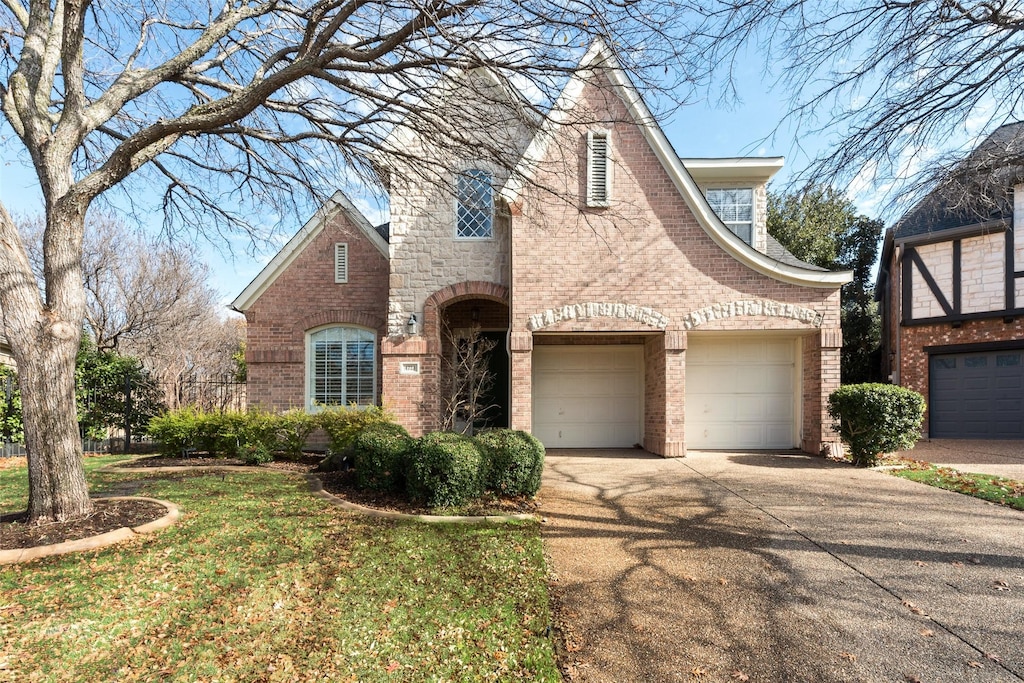 view of front of house with a garage and a front lawn