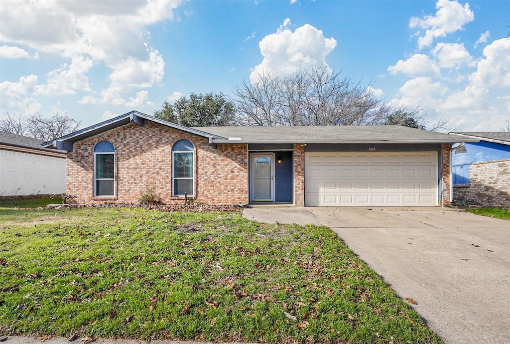 single story home with a garage and a front lawn