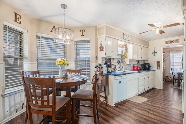 kitchen featuring dishwasher, hanging light fixtures, dark hardwood / wood-style flooring, a textured ceiling, and white cabinets