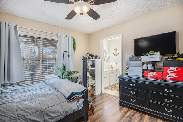 bedroom featuring a textured ceiling, dark hardwood / wood-style floors, ensuite bath, and ceiling fan