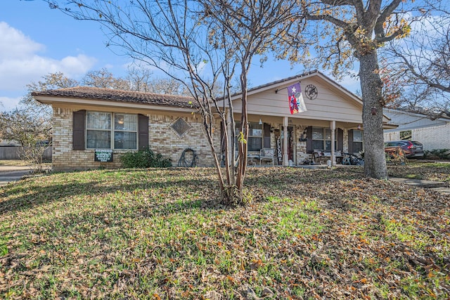 view of front of home with a porch and a front yard