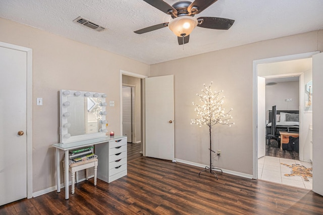 office area featuring a textured ceiling, dark hardwood / wood-style floors, and ceiling fan