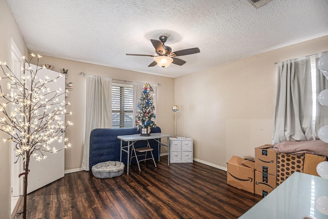 home office featuring a textured ceiling, dark hardwood / wood-style flooring, and ceiling fan