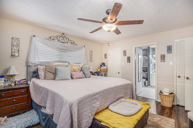 bedroom with a textured ceiling, dark hardwood / wood-style floors, ensuite bath, and ceiling fan