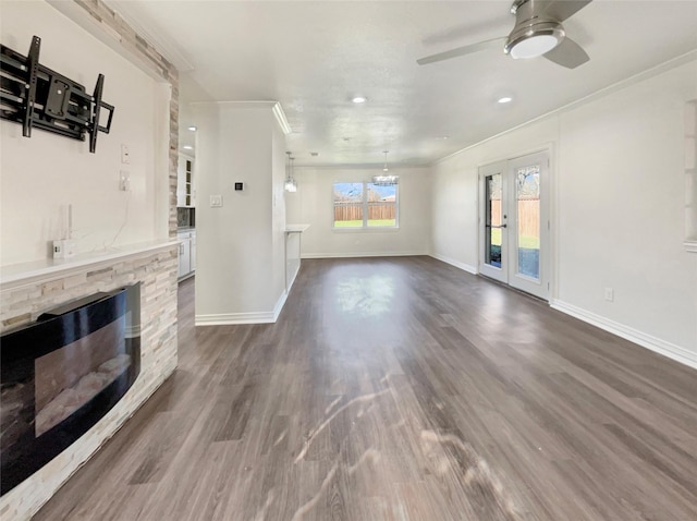 living room with a fireplace, dark hardwood / wood-style flooring, ceiling fan, and crown molding