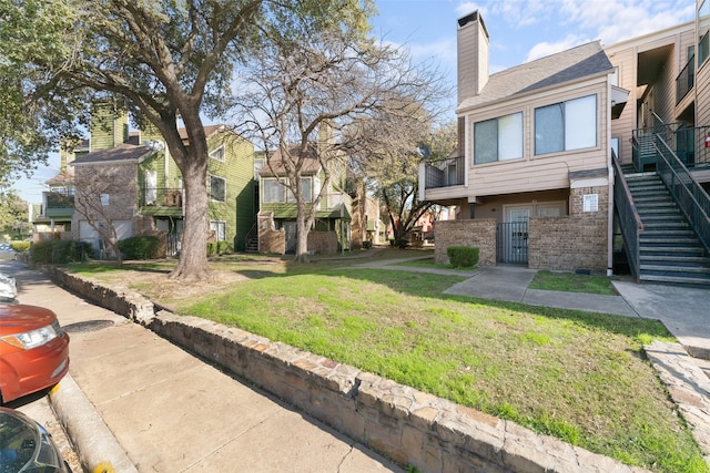 view of home's community with a lawn