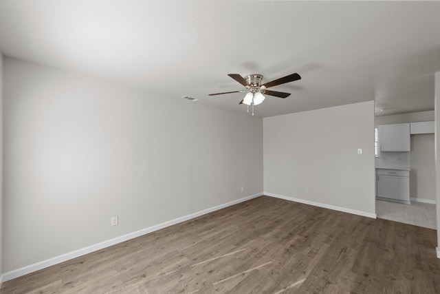 spare room featuring wood-type flooring and ceiling fan