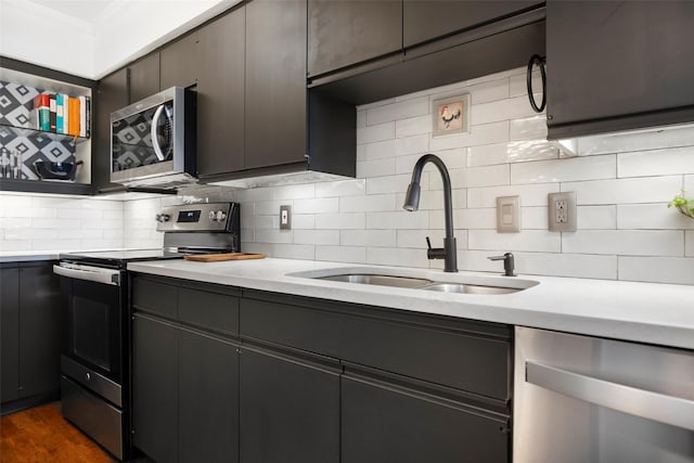 kitchen featuring decorative backsplash, sink, stainless steel appliances, and dark hardwood / wood-style floors