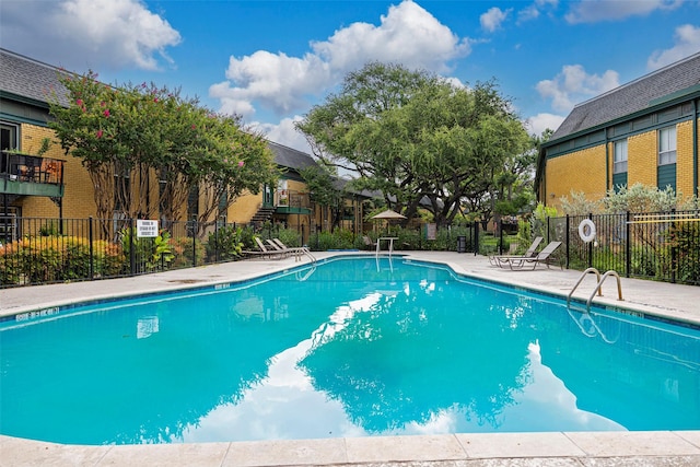 view of swimming pool with a patio