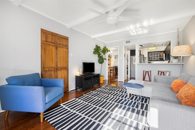 living room with ceiling fan, dark hardwood / wood-style flooring, and beamed ceiling