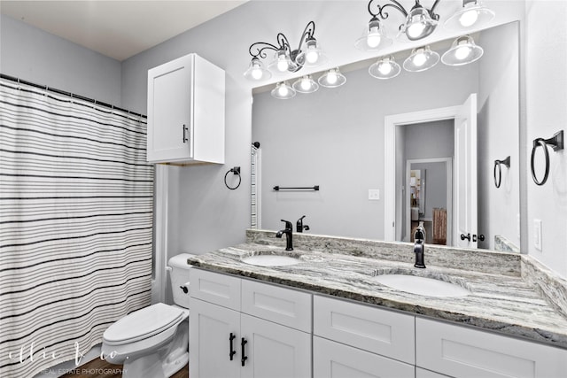 bathroom featuring vanity, toilet, and walk in shower