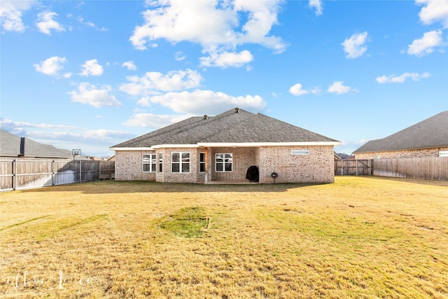 back of house with a lawn