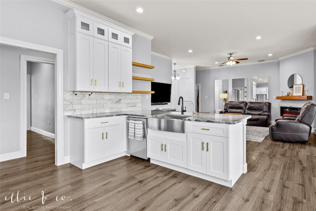 kitchen with white cabinetry, sink, and ornamental molding