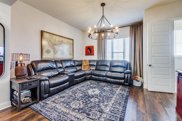 living room featuring dark wood-type flooring and a chandelier