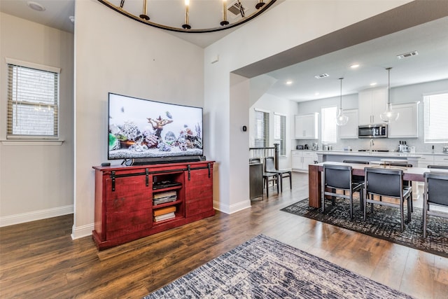 dining area featuring dark hardwood / wood-style floors, plenty of natural light, and sink