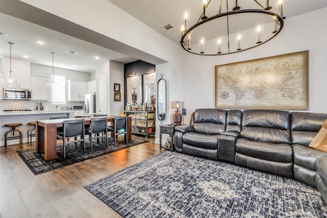 living room with a chandelier and hardwood / wood-style flooring