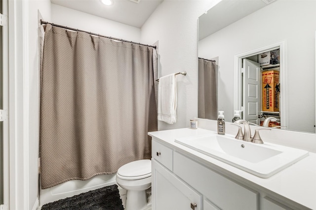 full bathroom with vanity, shower / bath combination with curtain, and toilet