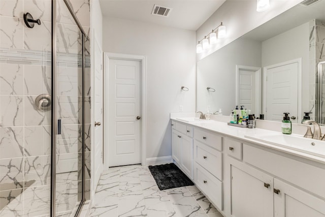 bathroom with vanity and a shower with shower door