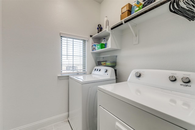 washroom featuring washer and clothes dryer and light tile patterned flooring