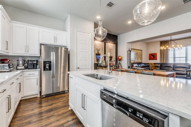 kitchen featuring sink, decorative light fixtures, and appliances with stainless steel finishes