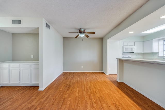 unfurnished living room featuring ceiling fan, a textured ceiling, and light wood-type flooring