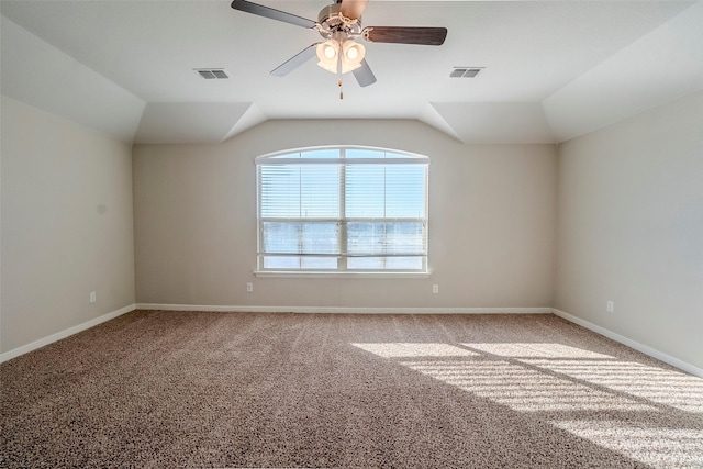 carpeted spare room featuring ceiling fan and lofted ceiling