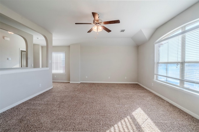 spare room with ceiling fan and carpet