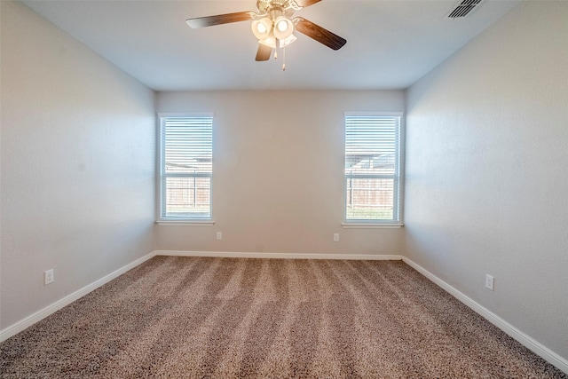 empty room featuring ceiling fan, a healthy amount of sunlight, and carpet floors