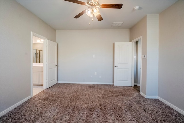 unfurnished bedroom featuring ceiling fan, light colored carpet, and ensuite bathroom