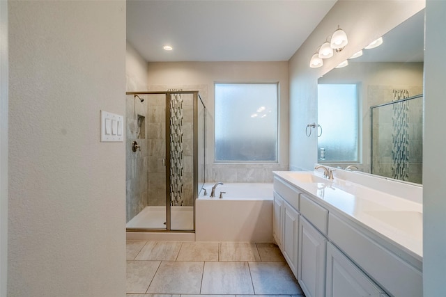 bathroom with shower with separate bathtub, vanity, and tile patterned floors