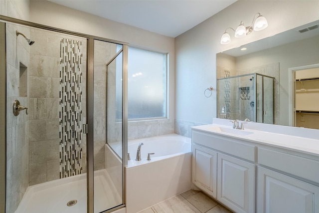 bathroom with independent shower and bath, tile patterned flooring, and a healthy amount of sunlight