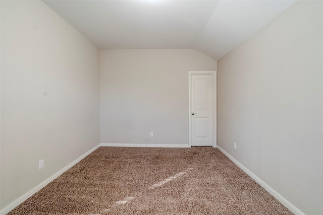 unfurnished room with lofted ceiling and carpet floors