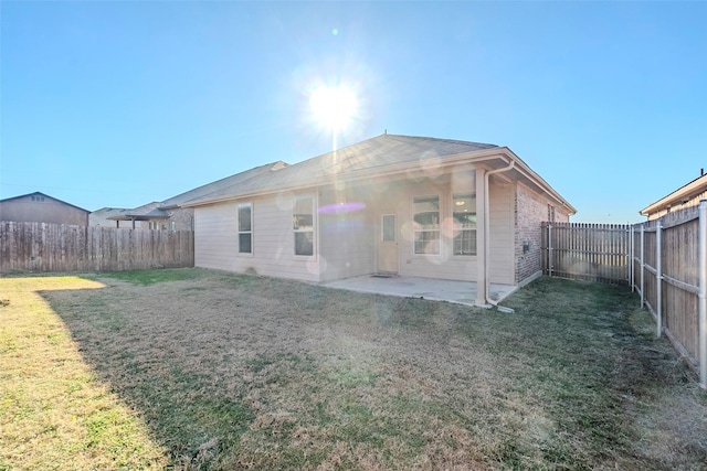 rear view of property with a lawn and a patio area