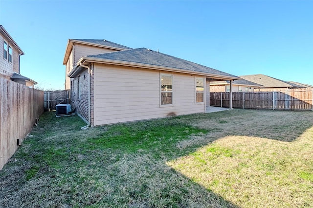 back of house with a lawn and cooling unit