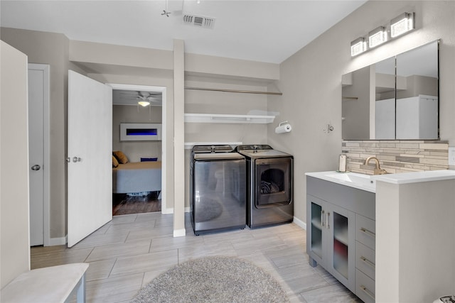 bathroom featuring vanity, independent washer and dryer, backsplash, and ceiling fan