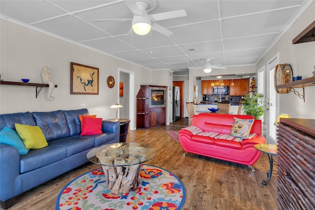 living room with ceiling fan and light hardwood / wood-style floors