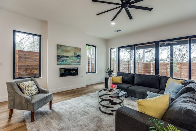 living room featuring light wood-type flooring and ceiling fan