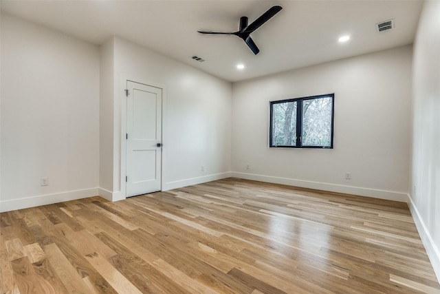 empty room featuring ceiling fan and light hardwood / wood-style floors