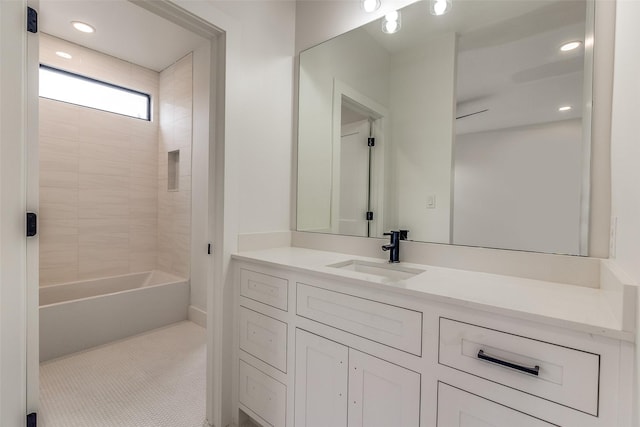 bathroom featuring tile patterned flooring, bathtub / shower combination, and vanity