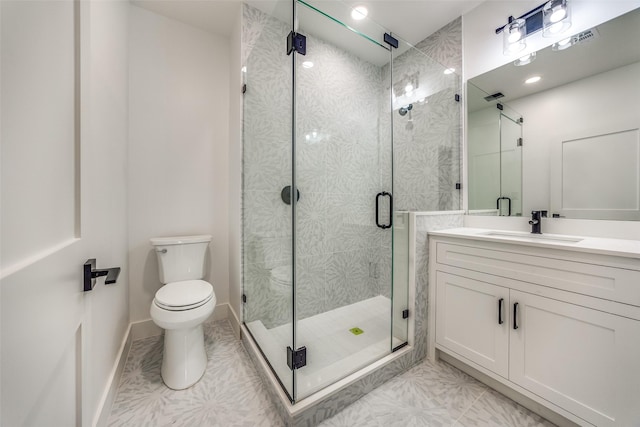 bathroom with tile patterned flooring, a shower with door, vanity, and toilet