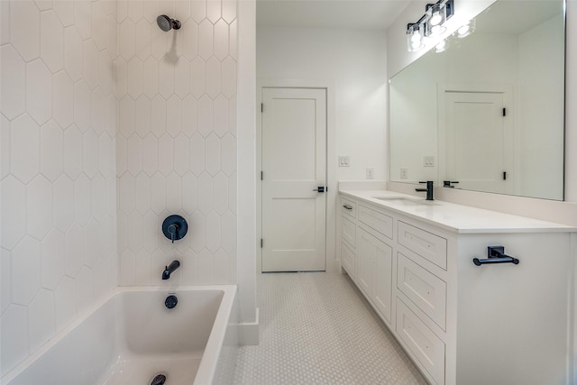 bathroom with tile patterned flooring, vanity, and tiled shower / bath