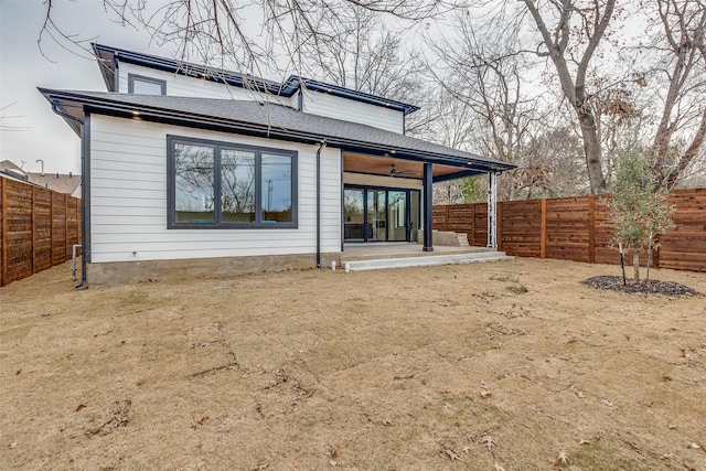 rear view of house with ceiling fan and a patio area