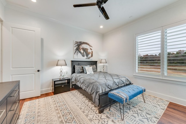 bedroom with light hardwood / wood-style floors, ceiling fan, and ornamental molding